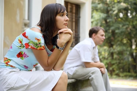 frustrated couple sitting on the curb