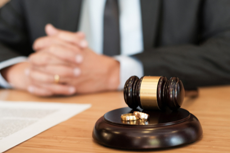 lawyer with gavel and wedding rings