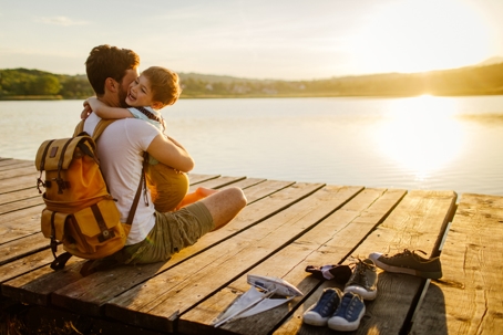 father and son hugging at the dock