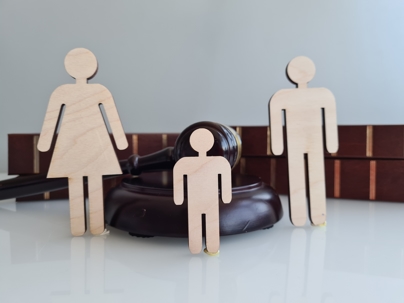 Wooden family next to gavel