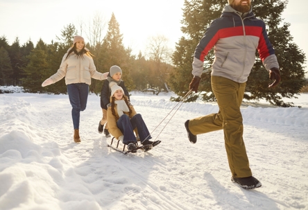 family playing in the snow